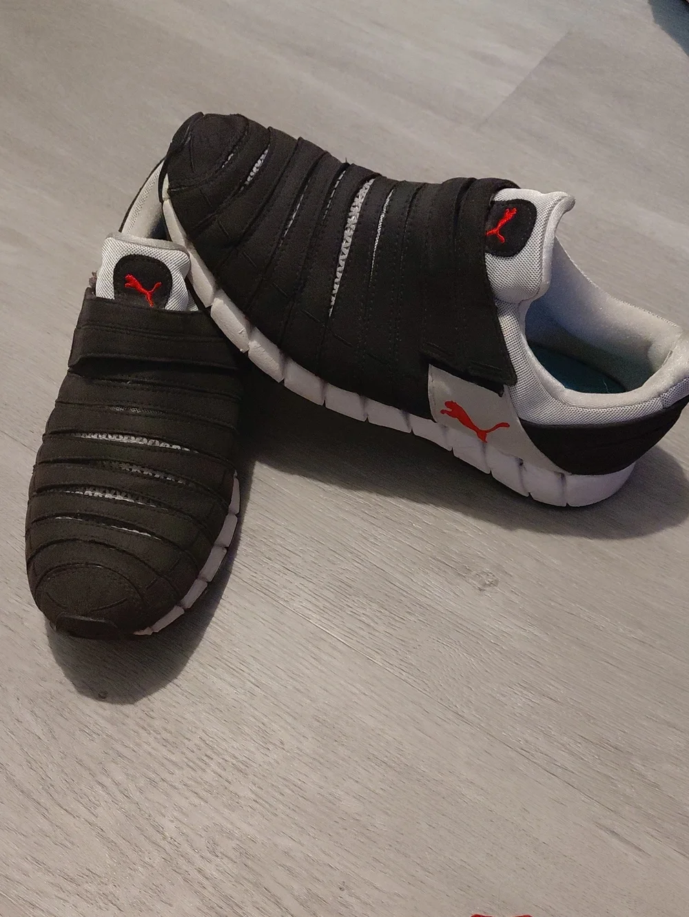 Puma Black Slip-On Sneakers with White Sole and Red Logo
